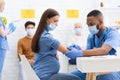 Pregnant Woman In Mask Getting Vaccinated Against Covid-19 In Hospital Royalty Free Stock Photo