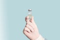 Coronavirus vaccine bottle. Phial with vaccine against COVID-19 in scientis`s hand in research laboratory. Royalty Free Stock Photo
