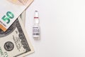 Coronavirus vaccine cost. vaccine ampoule and money. Fight against Covid-19. Pevention, immunization and treatment Royalty Free Stock Photo