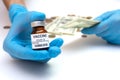 Coronavirus vaccine cost. vaccine ampoule and money. Fight against Covid-19. Pevention, immunization and treatment Royalty Free Stock Photo