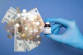 Coronavirus vaccine cost. vaccine ampoule and money. Fight against Covid-19. Pevention, immunization and treatment Royalty Free Stock Photo