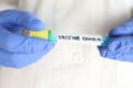 Coronavirus vaccine covid-19 hand-held test tube by biotechnology scientist