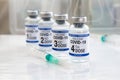 COVID-19 vaccine vials for vaccination labeled with 1st, 2nd, 3rd and 4th doses for booster shot against omicron variants Royalty Free Stock Photo