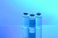 Coronavirus vaccine. Vaccine values during the acute period of the covid-19 pandemic concept. Vials on a blue background