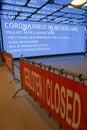 Coronavirus warning alert on electronic billboard with barriers blocking entry