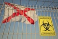 Coronavirus warning sign on the barbed wire fence against flag of Alabama. COVID-19 quarantine related 3D rendering