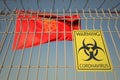 Coronavirus warning sign on the barbed wire fence near flag of Navarre, an autonomous community in Spain. COVID-19