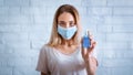 Coronavirus will not pass. Woman in mask holds antiseptic Royalty Free Stock Photo