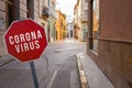 Coronavirus written on stop sign with empty old town street in Spain Royalty Free Stock Photo