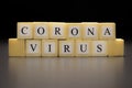 CORONAVIRUS written on wooden cubes isolated on a black background Royalty Free Stock Photo