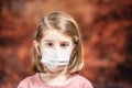 Coronovirus Quarantine, Stay Home Concept. Covid-19 pandemic. Little girl Wearing Surgical Mask