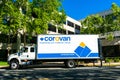 Corovan logo, sign on truck at commercial office building. Corovan is a full-service full-service commercial moving company. - San