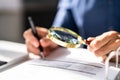 Corporate Auditor Using Magnifying Glass