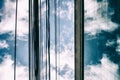 Clouds in a blue sky reflected in glass windows of an office building Royalty Free Stock Photo
