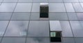 Corporate building panoramic glass wall reflecting clouds Royalty Free Stock Photo