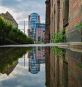 Corporate building tower reflected in puddle Royalty Free Stock Photo