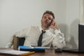 Corporate business lifestyle portrait of stressed and exhausted businessman working frustrated at office computer desk overworked Royalty Free Stock Photo