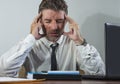 Corporate business lifestyle portrait of stressed and exhausted businessman working frustrated at office computer desk overworked Royalty Free Stock Photo