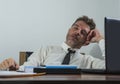 Corporate business lifestyle portrait of stressed and exhausted businessman working frustrated at office computer desk overworked Royalty Free Stock Photo