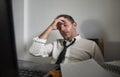 Corporate business lifestyle portrait of stressed and exhausted businessman working frustrated at office computer desk overworked Royalty Free Stock Photo