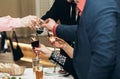 Corporate business man toasting at dinner party table hands close-up, wedding reception guests toast alcohol drinks in glasses Royalty Free Stock Photo