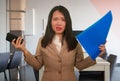 Corporate business stress portrait of young attractive upset and stressed executive Asian Chinese woman tired and unhappy holding Royalty Free Stock Photo