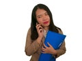 Corporate business stress portrait of young attractive upset and stressed executive Asian Korean woman talking on mobile phone Royalty Free Stock Photo