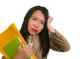 Corporate business stress portrait of young attractive upset and stressed executive Asian Korean woman tired and unhappy holding Royalty Free Stock Photo