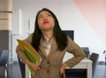 Corporate business stress portrait of young attractive upset and stressed executive Asian Korean woman tired and unhappy holding Royalty Free Stock Photo