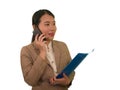 Corporate business success portrait of young attractive happy and confident executive Asian Korean woman talking on mobile phone Royalty Free Stock Photo