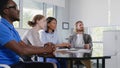 Corporate business team sitting in meeting room listening to leader Royalty Free Stock Photo