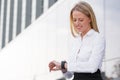 Corporate business woman looking at watch and smiling Royalty Free Stock Photo