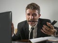 Corporate business work stress - young desperate and frustrated businessman working stressed and overwhelmed at office computer Royalty Free Stock Photo