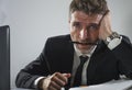 Corporate business work stress - young desperate and frustrated businessman working stressed and overwhelmed at office computer Royalty Free Stock Photo