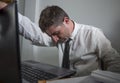 Corporate business work stress - young desperate and frustrated businessman working stressed and overwhelmed at office computer Royalty Free Stock Photo