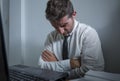 Corporate business work stress - young desperate and frustrated businessman working stressed and overwhelmed at office computer Royalty Free Stock Photo