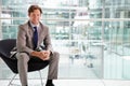 Corporate businessman sitting in modern interior