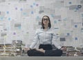 Corporate businesswoman practicing meditation in the office