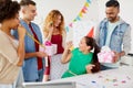 Team greeting colleague at office birthday party Royalty Free Stock Photo