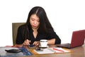 Corporate company portrait of young beautiful and busy Asian Chinese business woman working at office computer desk concentrated i Royalty Free Stock Photo