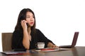 Corporate company portrait of young beautiful and busy Asian Chinese businesswoman working at office computer desk concentrated in Royalty Free Stock Photo