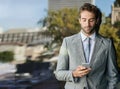Corporate, confidence and businessman on balcony with smartphone for networking, reading email or news. Lens flare Royalty Free Stock Photo