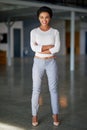 Corporate confidence. Full length portrait of a young businesswoman standing with her arms folded in the office. Royalty Free Stock Photo