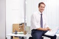 Corporate confidence. Portrait of a handsome young businessman reading through documents in his office. Royalty Free Stock Photo