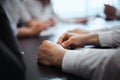 Corporate decision making. A group of businessmen shows and discusses something while colleagues are listening, sitting at a table