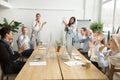 Corporate diverse team congratulating african coworker with busi