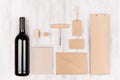 Corporate identity template for wine industry, blank beige kraft packaging on soft white wood background. Royalty Free Stock Photo