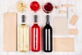 Corporate identity template for wine industry - blank packaging, stationery, wine bottles and glasses on soft white wood board. Royalty Free Stock Photo