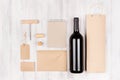 Corporate identity template for wine industry with bottle red wine on soft white wood background. Royalty Free Stock Photo