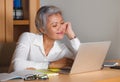 Corporate job lifestyle portrait of happy and successful attractive middle aged Asian woman working at office laptop computer desk Royalty Free Stock Photo